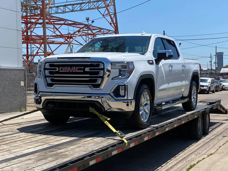 GMC loaded on flatbed for long-distance tow